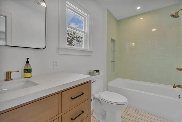 a bathroom with a sink a toilet and bathtub