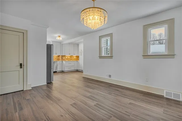 a view of room with wooden floor and window