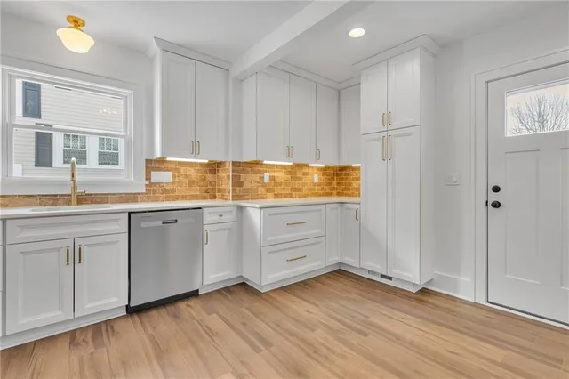 a kitchen with granite countertop white cabinets and white appliances