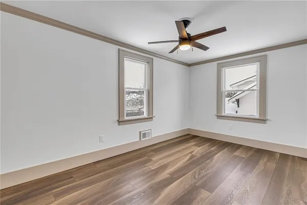 wooden floor in an empty room with a window
