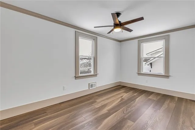 wooden floor in an empty room with a window