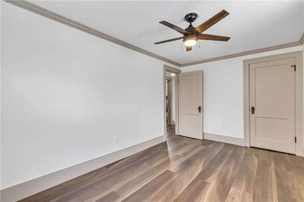 a view of empty room with wooden floor