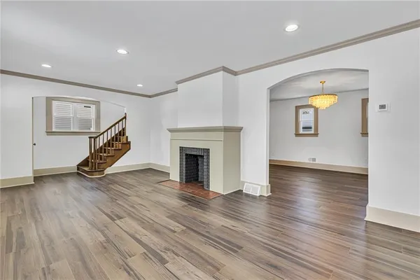 a view of a livingroom with wooden floor and a ceiling fan