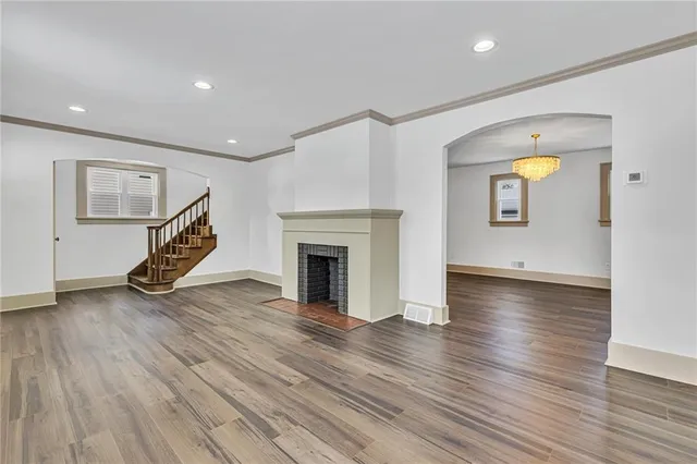 a view of a livingroom with wooden floor and a ceiling fan
