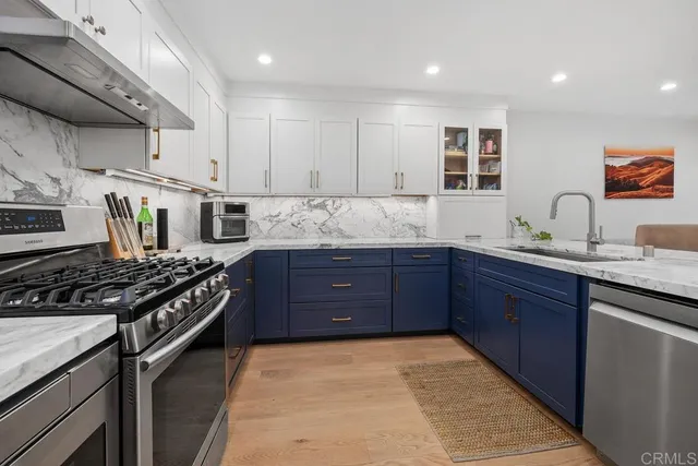 a kitchen with granite countertop a stove and a sink