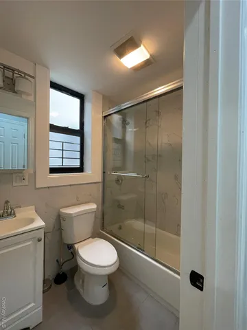a bathroom with a toilet a sink and shower