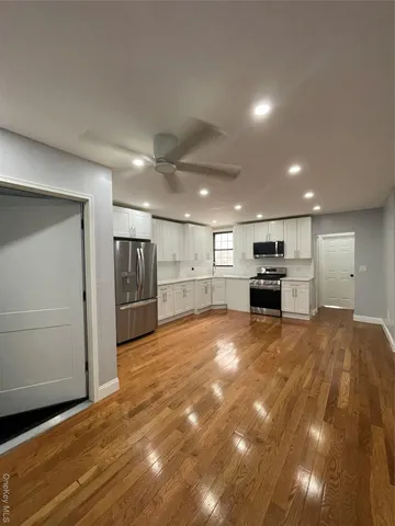 a view of kitchen with refrigerator and a stove