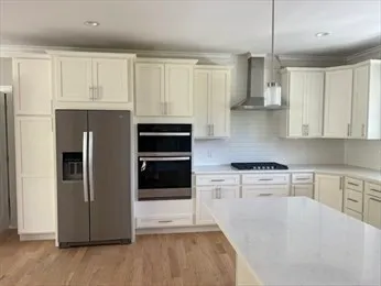 a kitchen with stainless steel appliances a refrigerator sink and cabinets