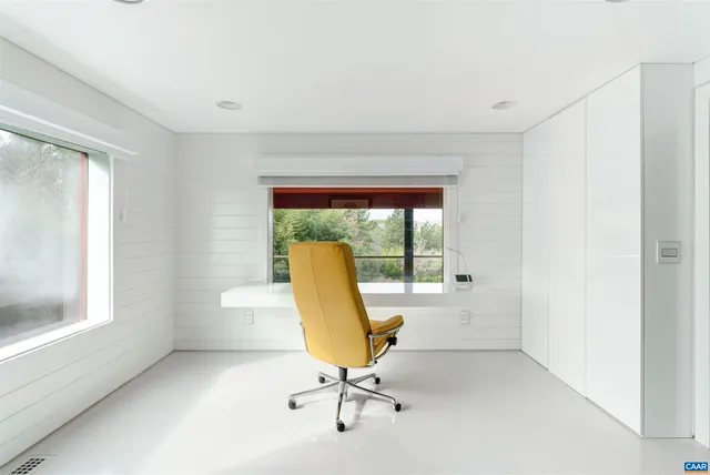 a view of a dining room with furniture and window