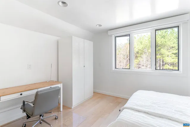 a view of a porch with wooden floor and outdoor seating