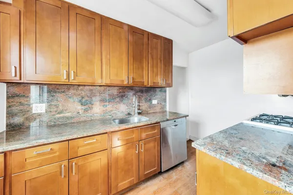 a kitchen with granite countertop cabinets and sink