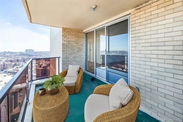 a balcony with furniture and a potted plant