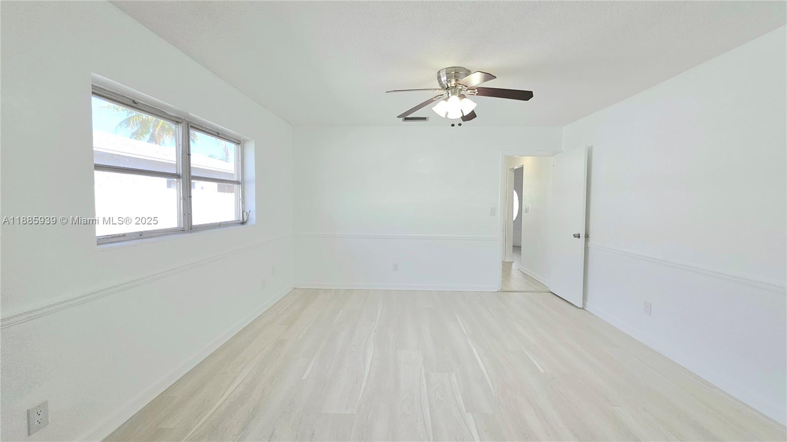 5300 Southwest 7th Court Margate, FL 33068 - Photo 17 of 18 wooden floor in an empty room with a window