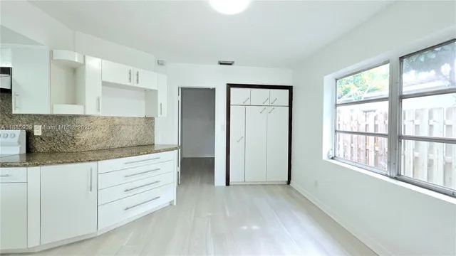 a living room with furniture and windows