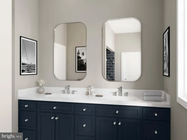 a bathroom with double vanity sinks and a mirror