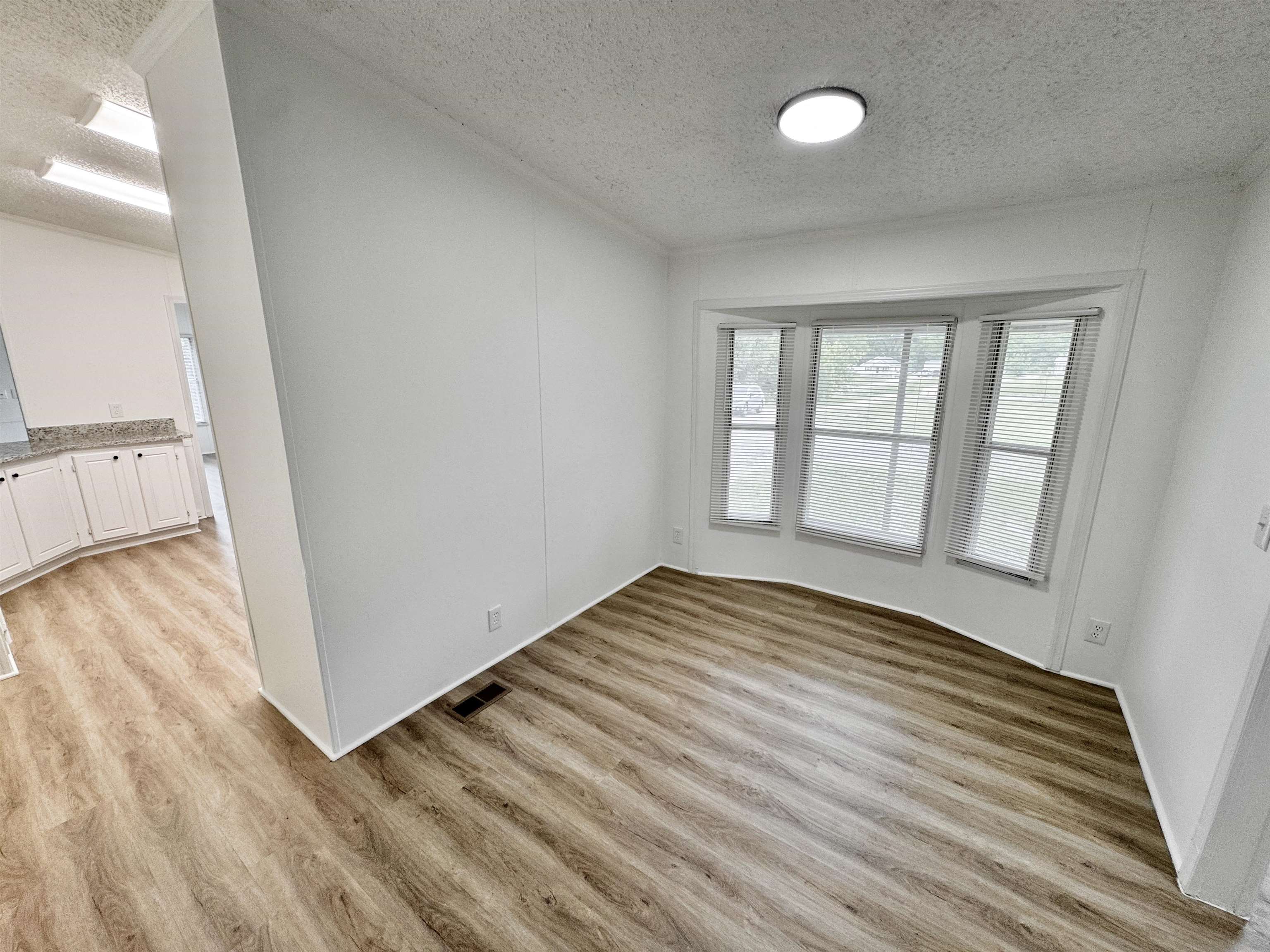 841 Simmons Road Drummonds, TN 38023 - Photo 12 of 35 Empty room featuring a textured ceiling and light wood-style floors