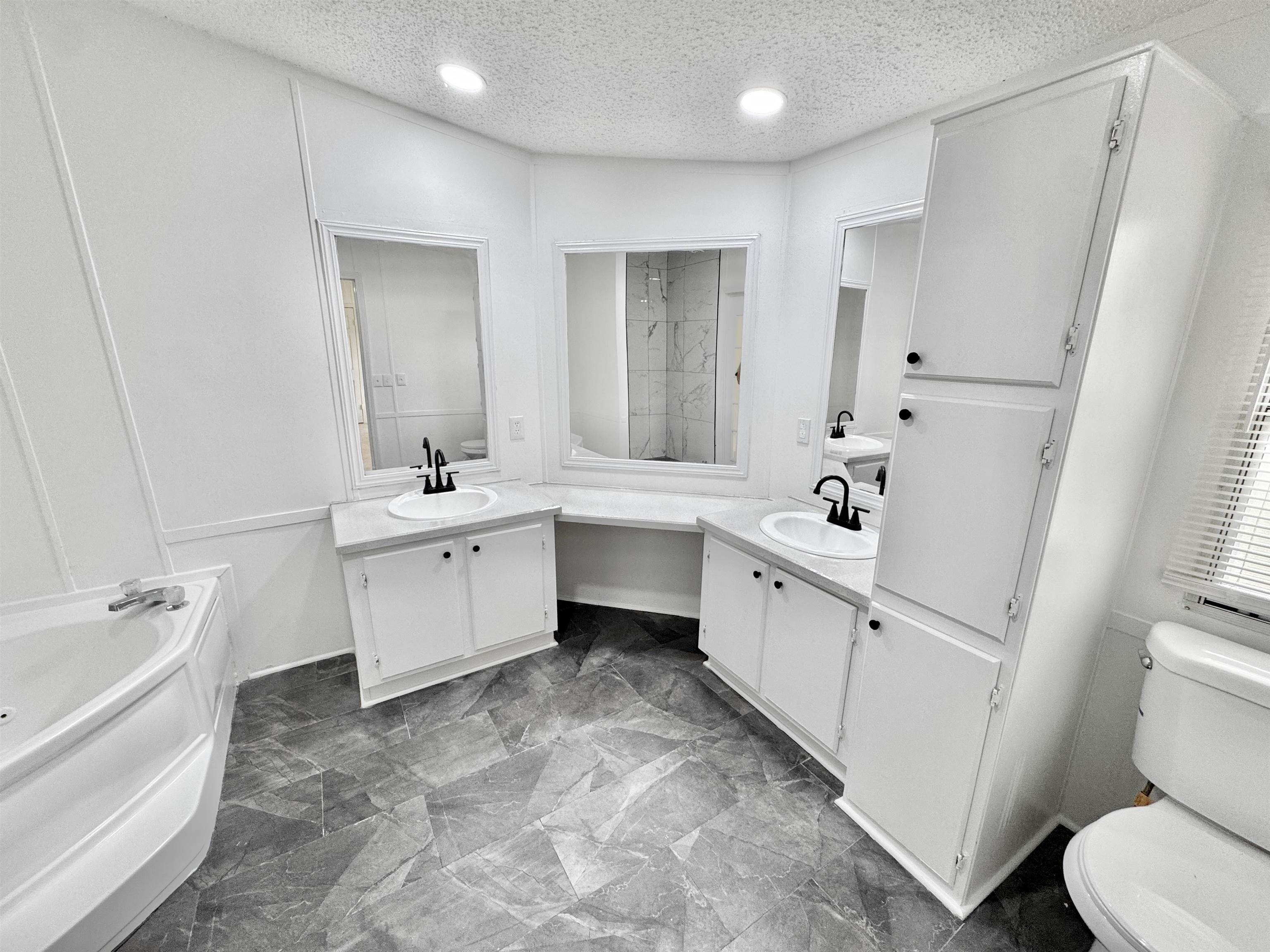 841 Simmons Road Drummonds, TN 38023 - Photo 18 of 35 Bathroom with toilet, a bath, two vanities, a textured ceiling, and recessed lighting