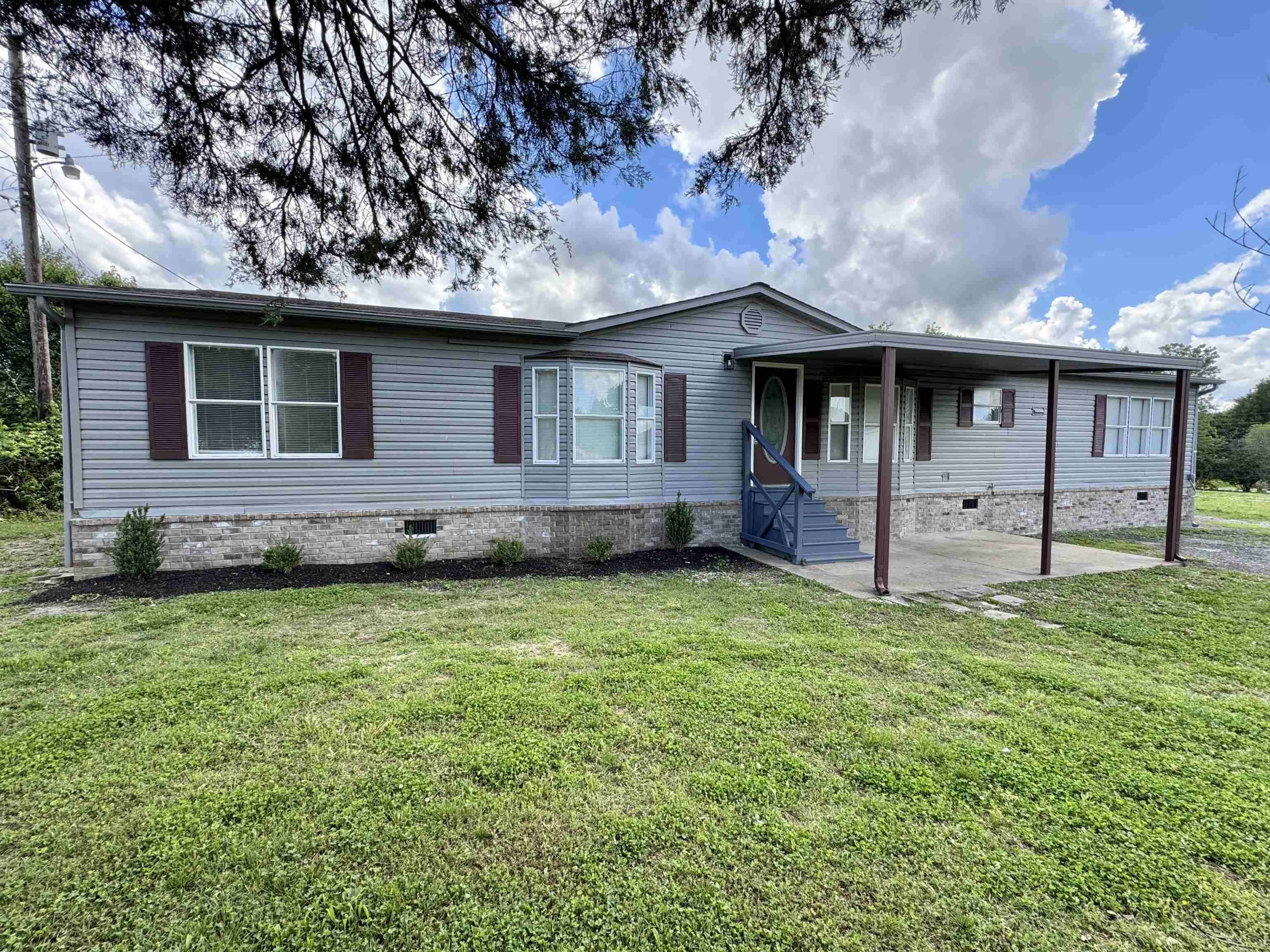 841 Simmons Road Drummonds, TN 38023 - Photo 2 of 35 Manufactured / mobile home featuring crawl space, a front yard, and a patio area