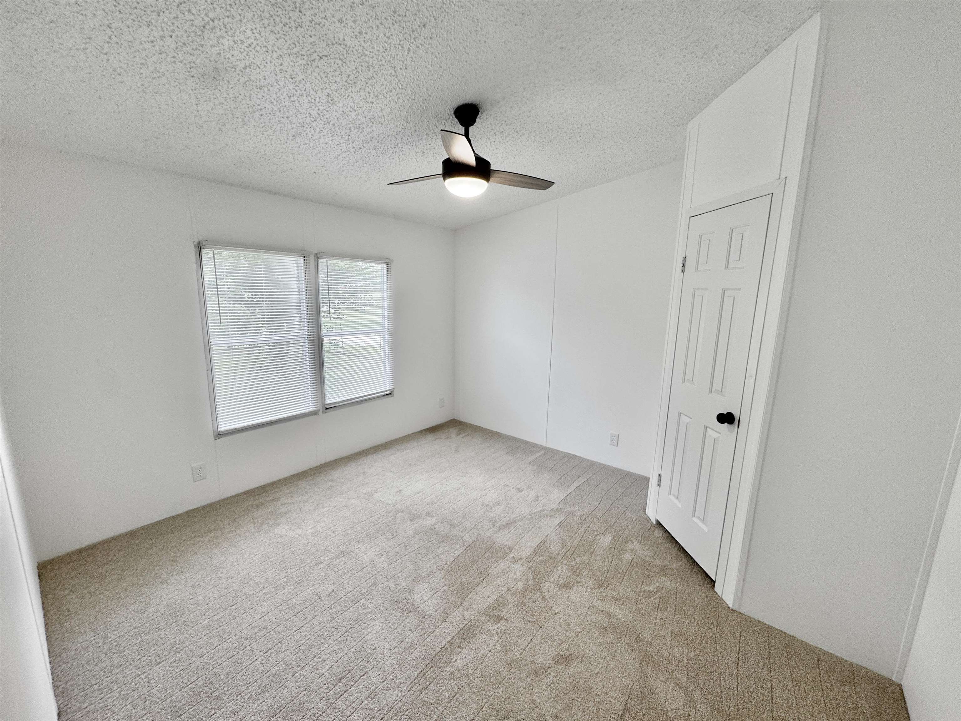 841 Simmons Road Drummonds, TN 38023 - Photo 22 of 35 Spare room featuring ceiling fan, carpet flooring, and a textured ceiling