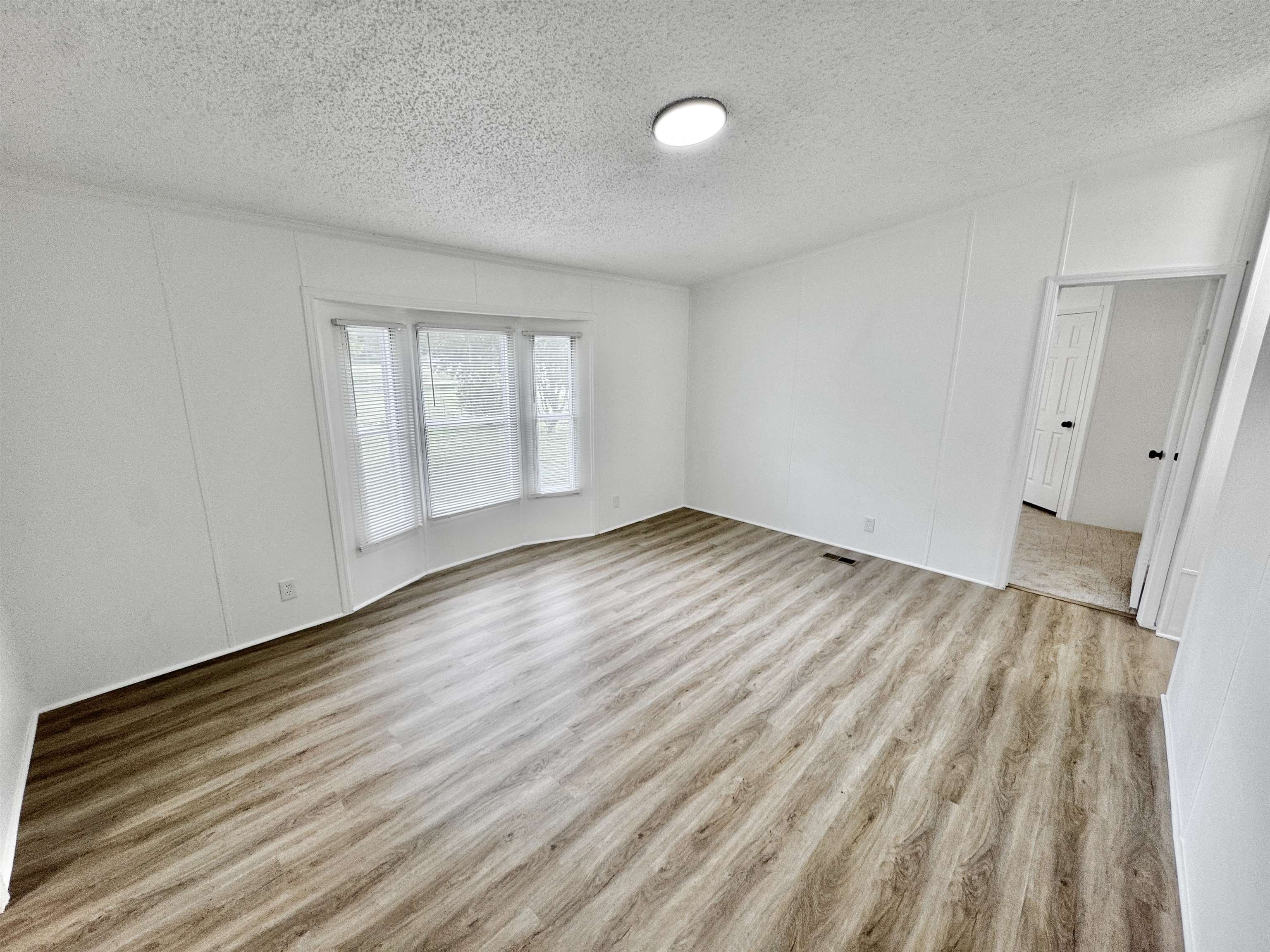 841 Simmons Road Drummonds, TN 38023 - Photo 10 of 35 Unfurnished room with a textured ceiling and wood finished floors