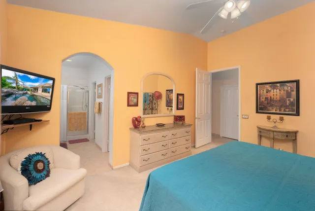 a bedroom with a bed and a television