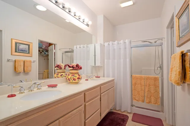 a bathroom with double vanity sink and a mirror