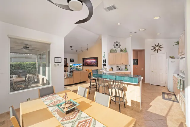 a living room with kitchen island furniture and a chandelier