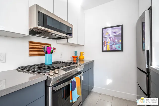 a kitchen with stainless steel appliances granite countertop a stove and a microwave