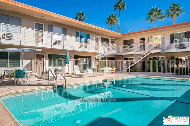 a view of a house with a yard patio and swimming pool