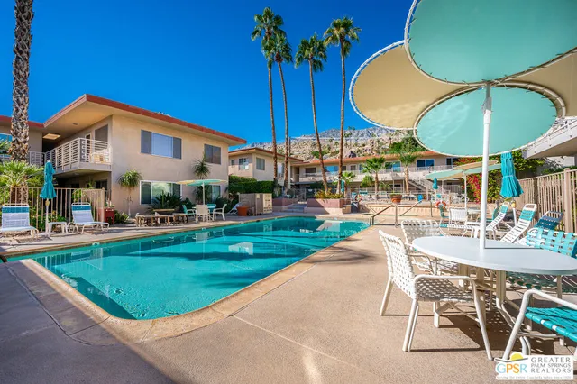 a view of a swimming pool with outdoor seating