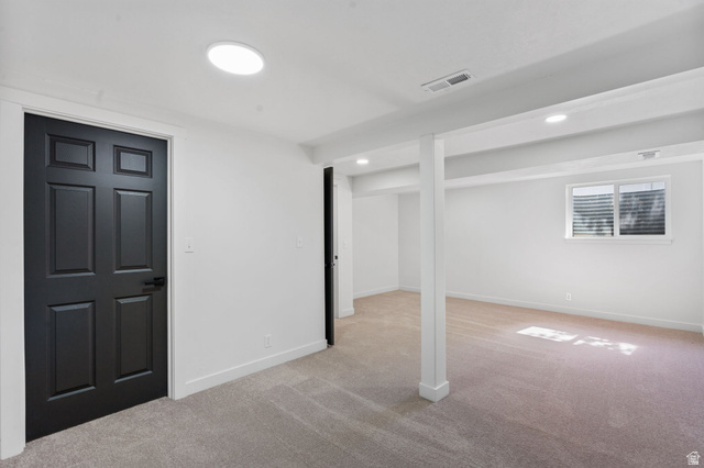 432 Calnette Drive Sandy, UT 84070 - Photo 25 of 48 Bright interior space featuring light-toned carpet, white walls, and a black six-panel door with matte black hardware