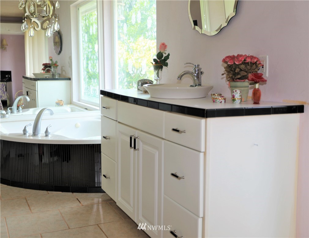11204 Southeast Petrovitsky Road Renton, WA 98055 - Photo 18 of 37 a bathroom with a sink vanity and a mirror