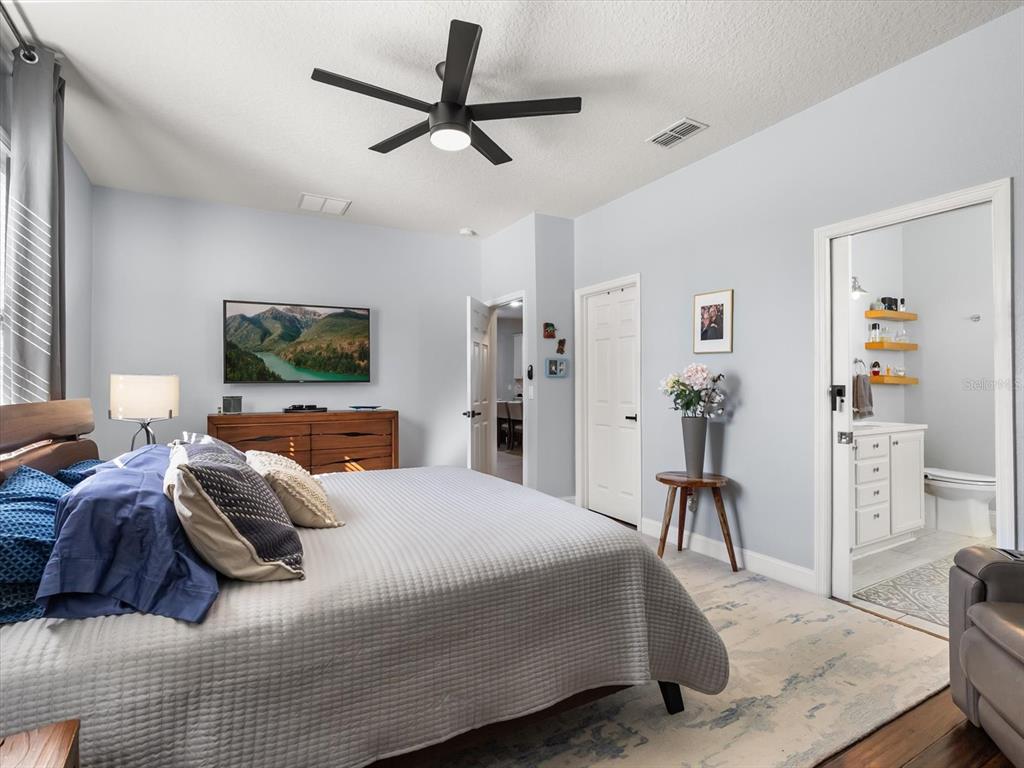 30021 Donnington Loop Mount Dora, FL 32757 - Photo 19 of 40 a bedroom with a bed and a flat screen tv