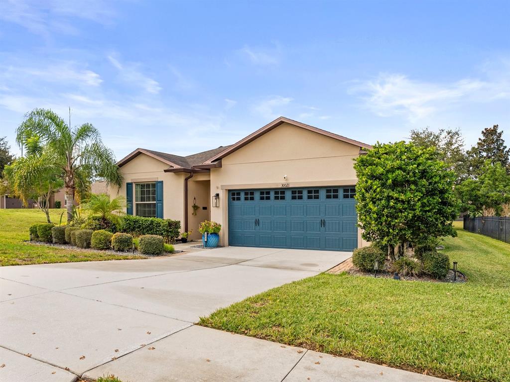 30021 Donnington Loop Mount Dora, FL 32757 - Photo 2 of 40 a front view of a house with a yard and garage