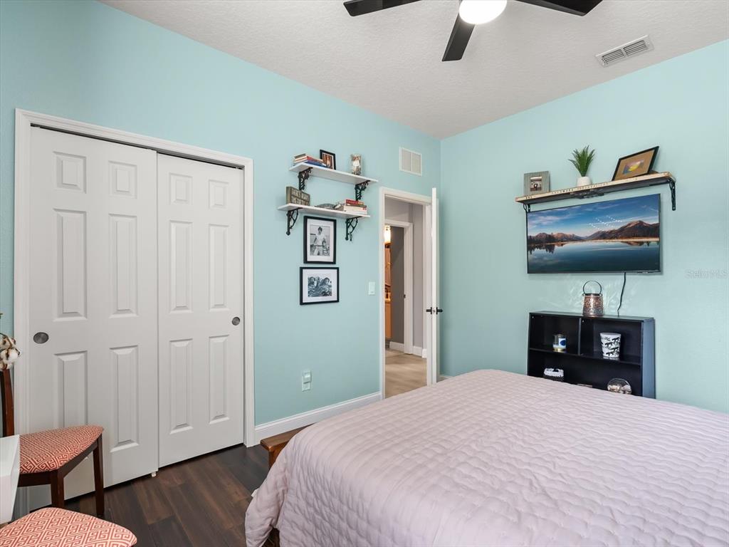 30021 Donnington Loop Mount Dora, FL 32757 - Photo 23 of 40 a bedroom with bed and wooden floor