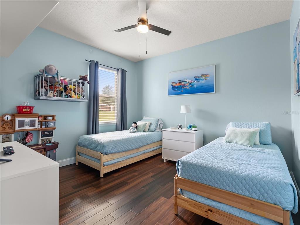 30021 Donnington Loop Mount Dora, FL 32757 - Photo 25 of 40 a bedroom with two beds and a desk