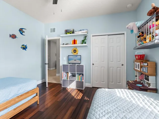 a bedroom with furniture and a book shelf