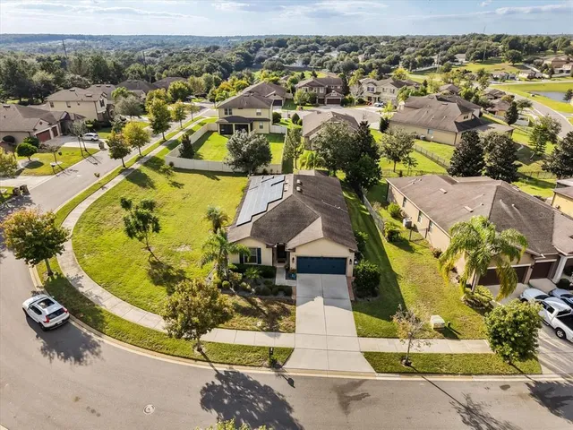 an aerial view of residential houses with outdoor space