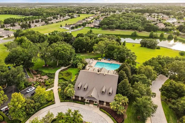 an aerial view of residential houses with outdoor space and river