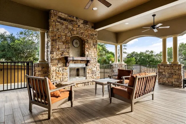 a building outdoor space with patio furniture and potted plants