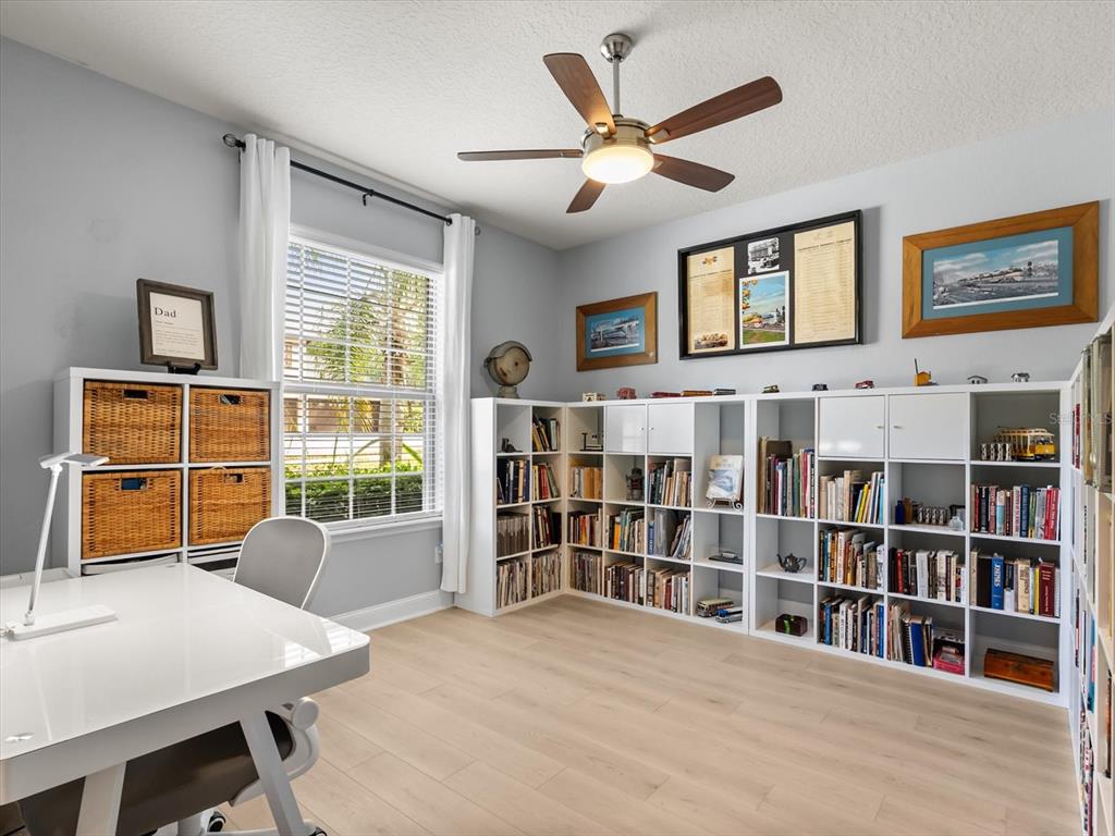 30021 Donnington Loop Mount Dora, FL 32757 - Photo 6 of 40 a living room with furniture and a book shelf