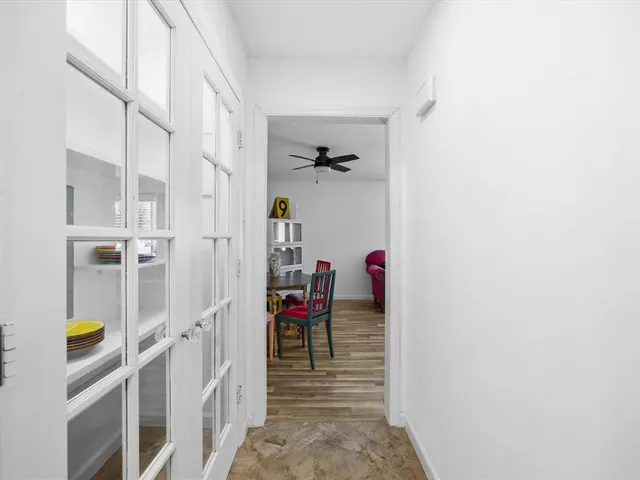 a view of hallway with seating area