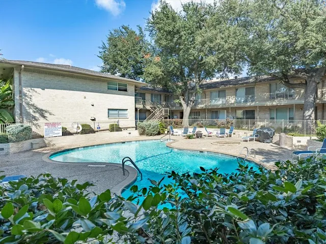 a view of a patio with table and chairs and potted plants