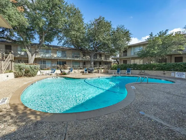 a view of a swimming pool with a patio and a yard