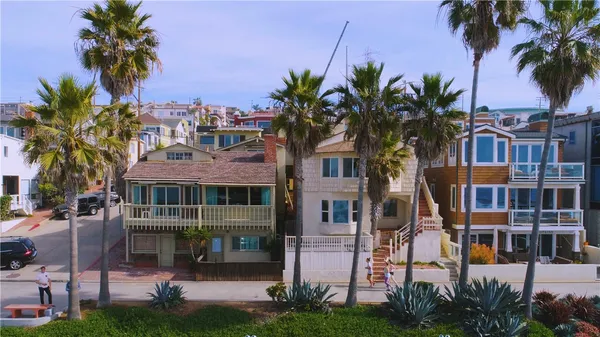 a front view of multiple houses with yard
