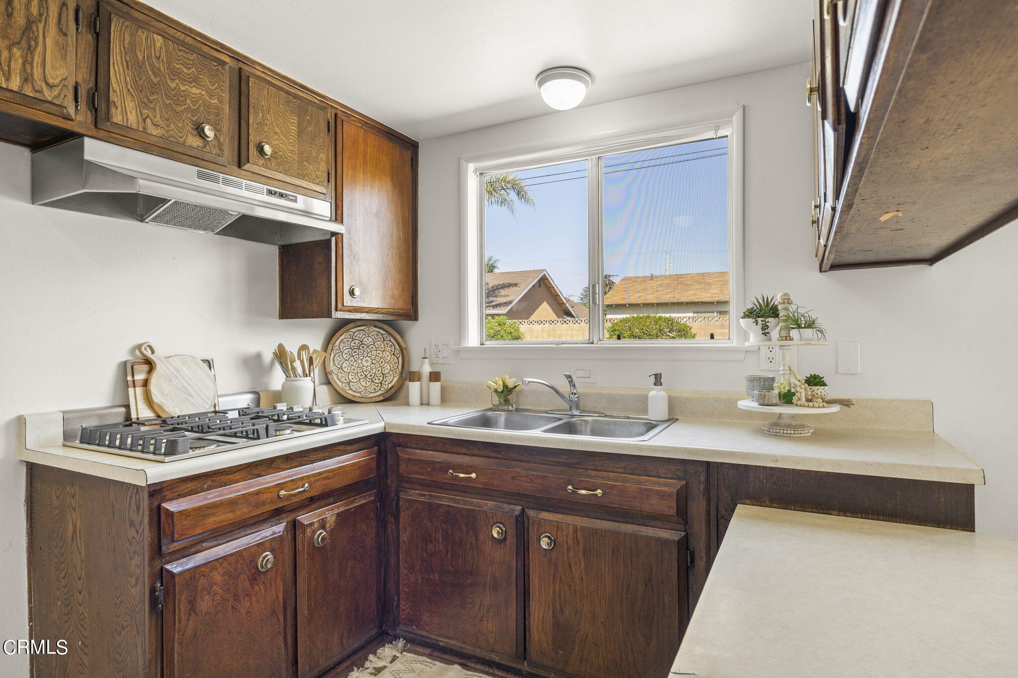 1225 Azalea Street Oxnard, CA 93036 - Photo 11 of 41 a kitchen with stainless steel appliances granite countertop a sink stove and cabinets