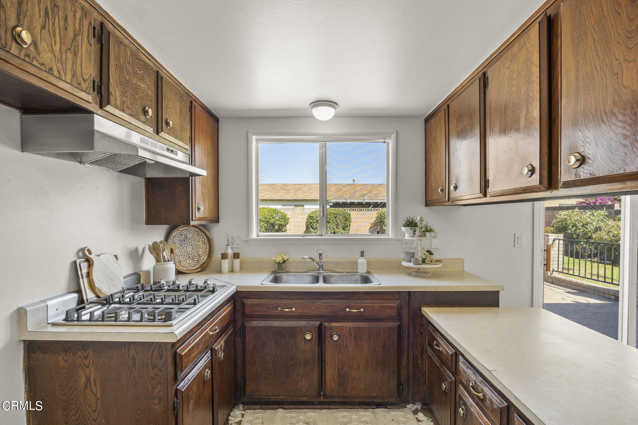 1225 Azalea Street Oxnard, CA 93036 - Photo 12 of 41 a kitchen with stainless steel appliances a sink stove and cabinets