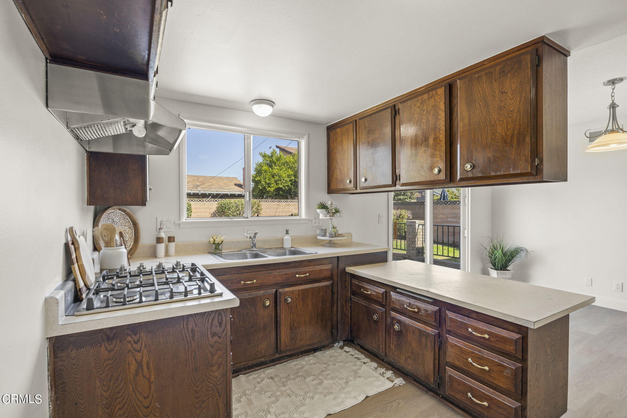 1225 Azalea Street Oxnard, CA 93036 - Photo 13 of 41 a kitchen with a sink stove and microwave