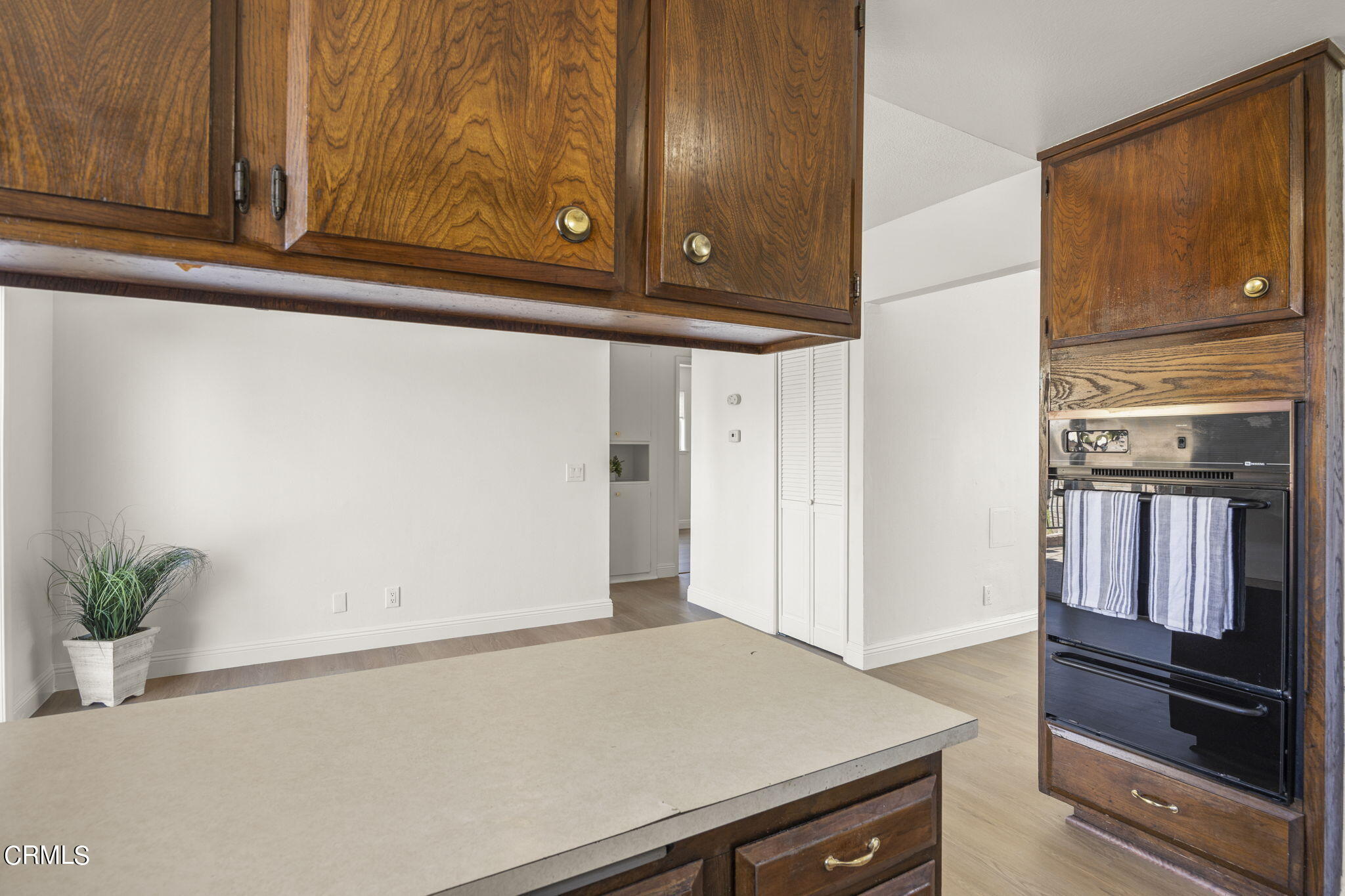 1225 Azalea Street Oxnard, CA 93036 - Photo 14 of 41 a kitchen with wooden cabinets and a stove top oven