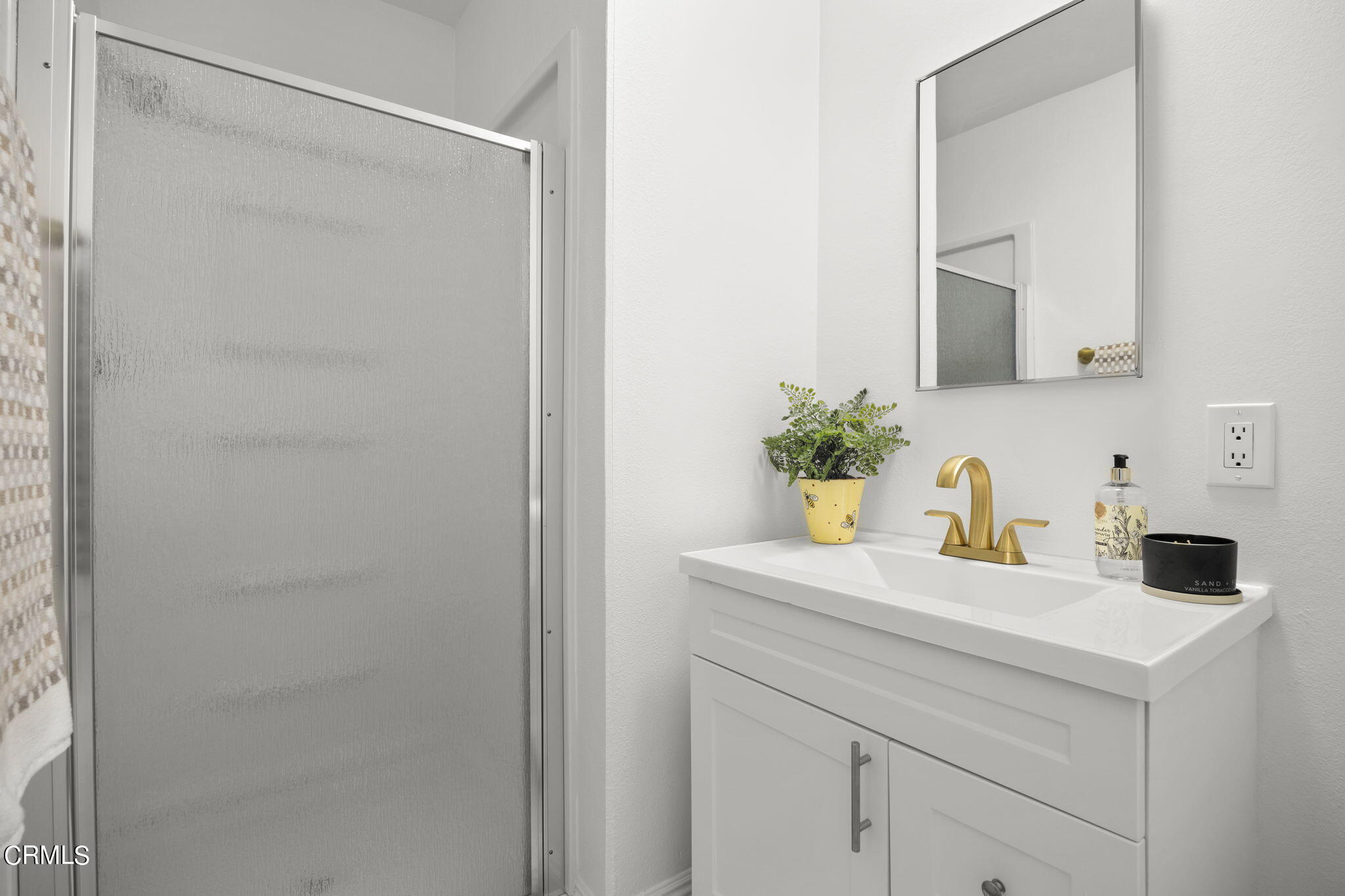 1225 Azalea Street Oxnard, CA 93036 - Photo 19 of 41 a bathroom with a granite countertop sink and a mirror